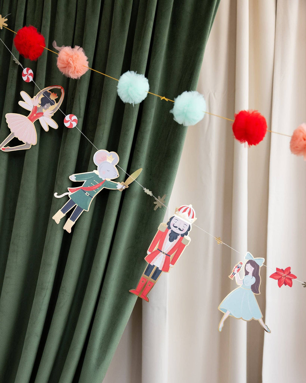 Decorative garland with nutcracker themed figures and pom poms
