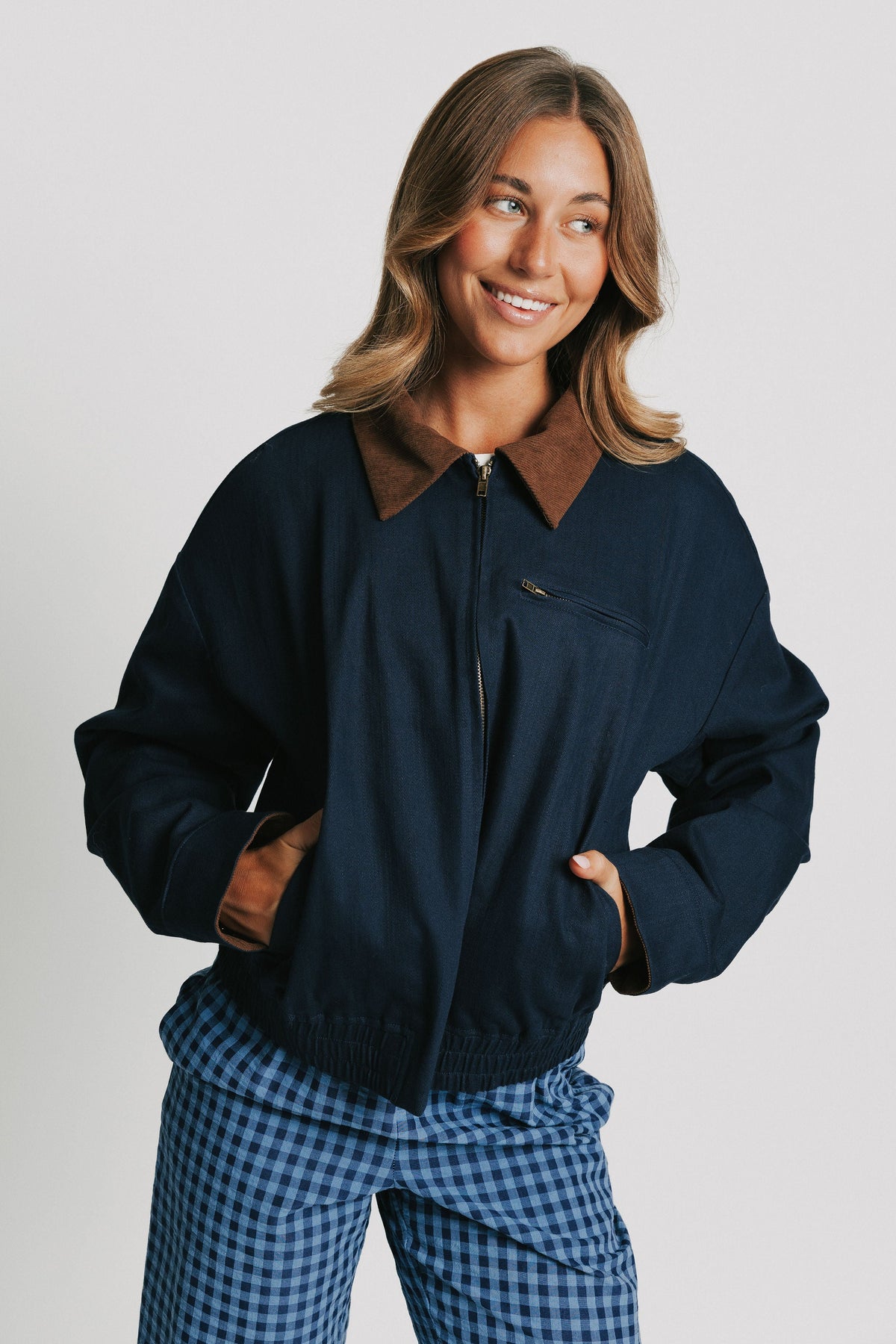 navy jacket with elastic waistband and brown collar 