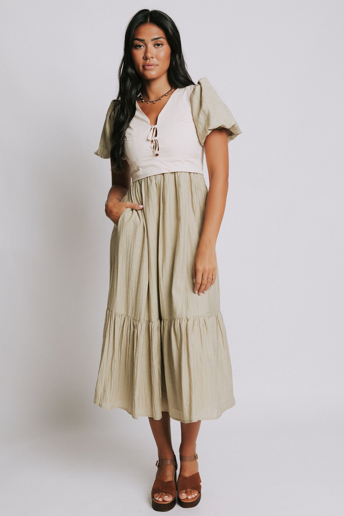 olive midi dress with cream vest and puff sleeves