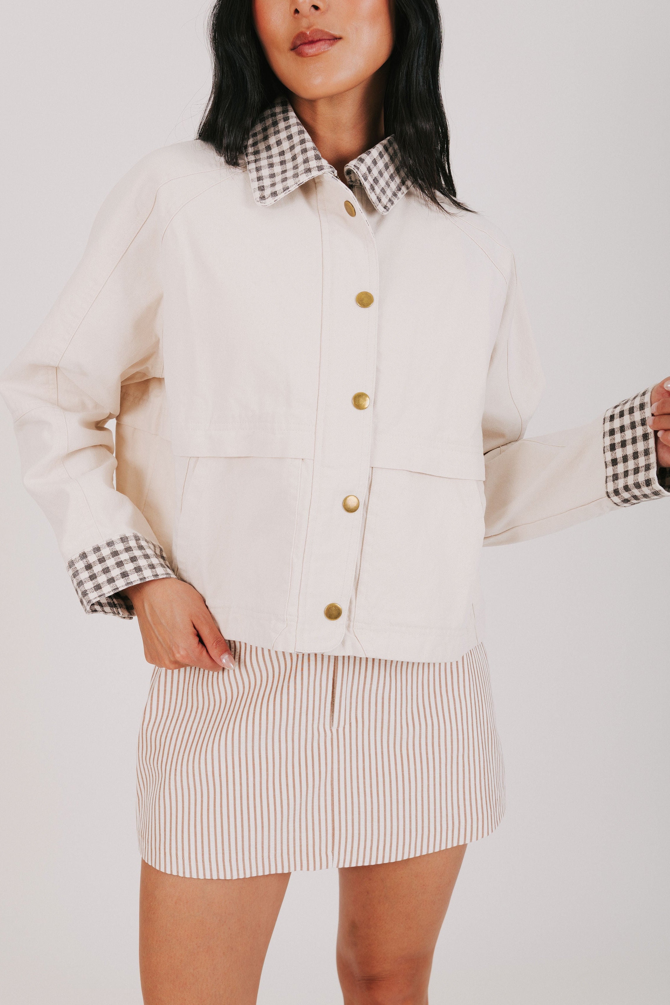 oversized cream jacket with checkered pattern on collar and cuffs front