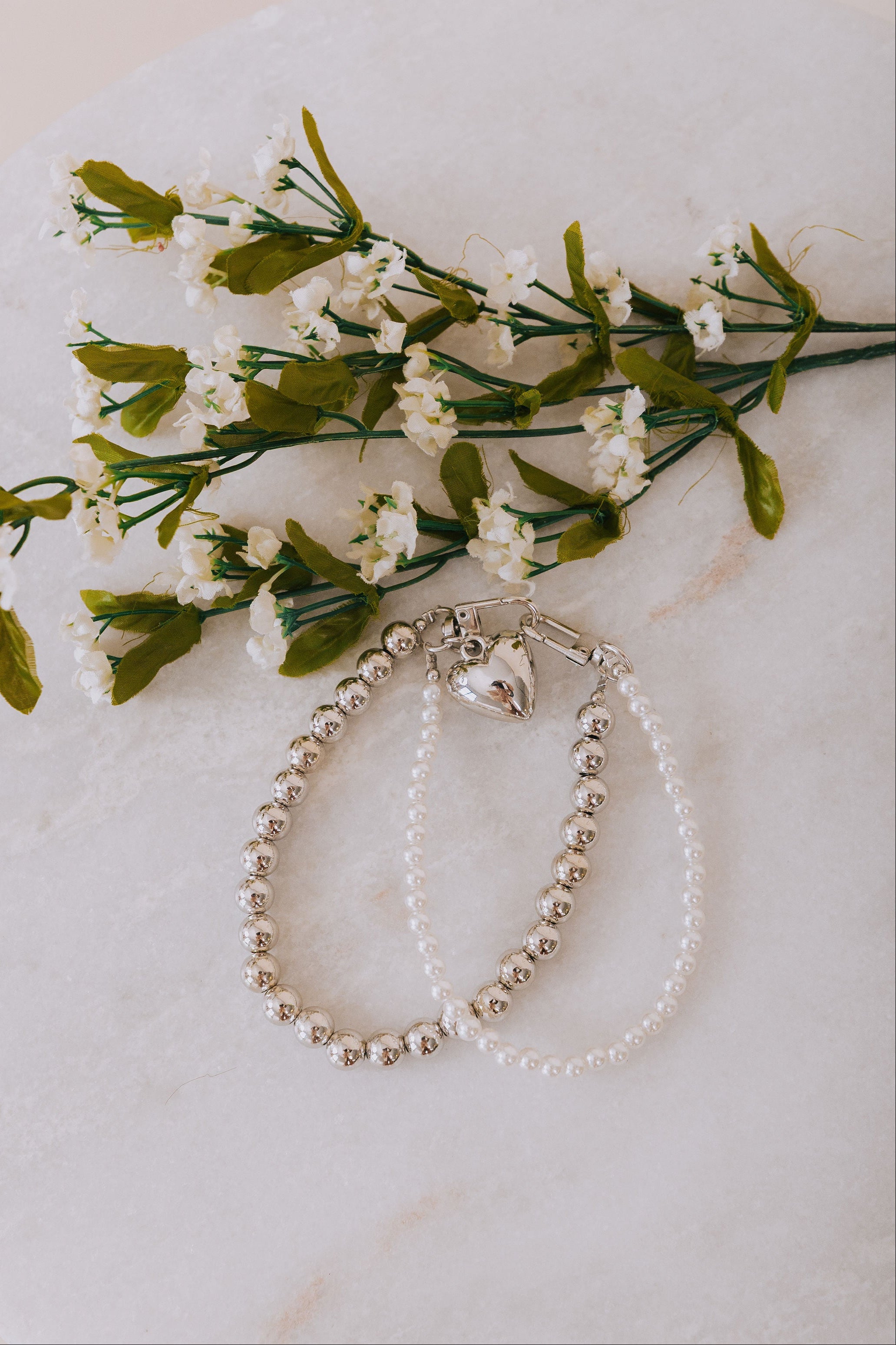 silver and pearl phone charm wristlet with heart
