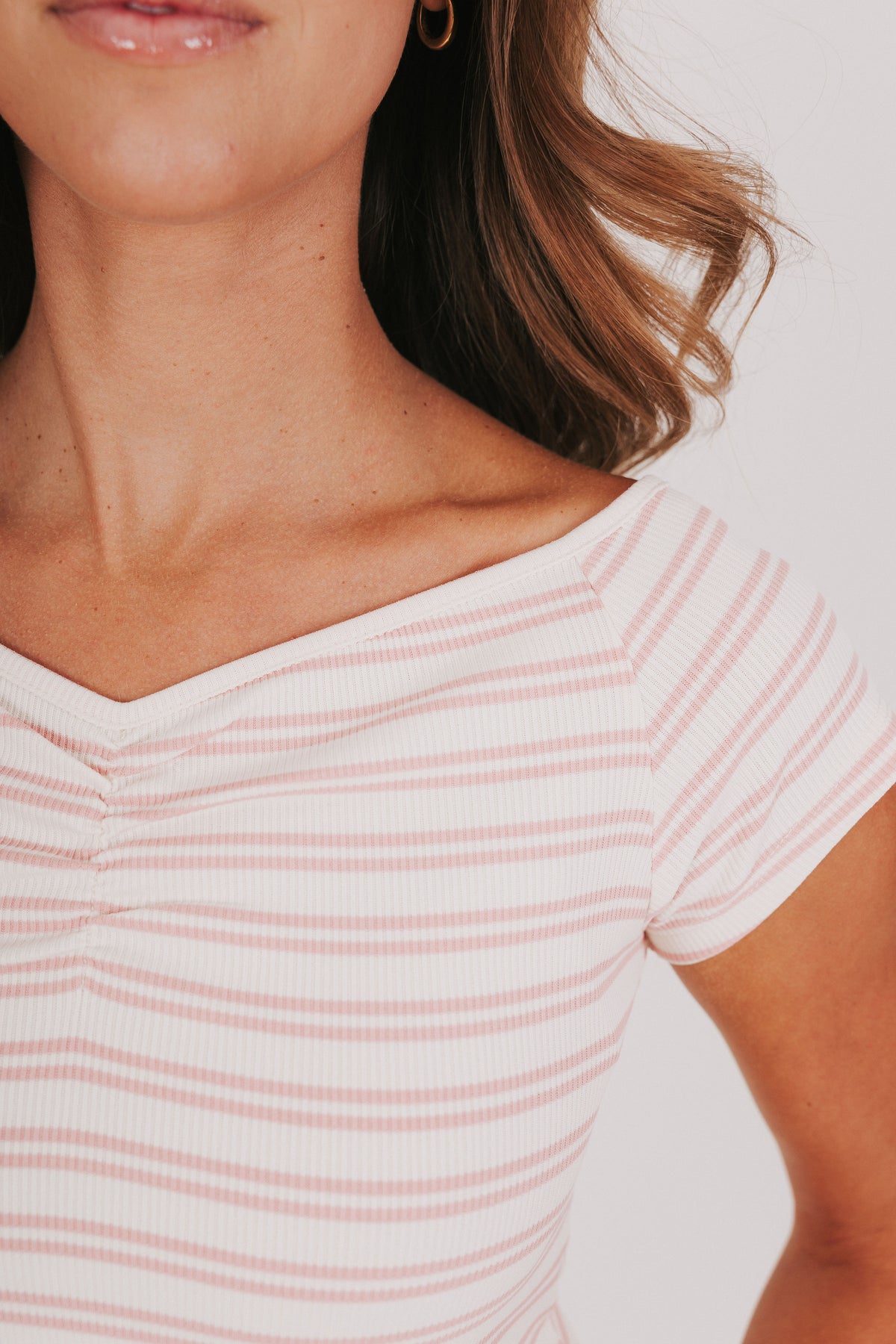 pink and white striped top with wide neck