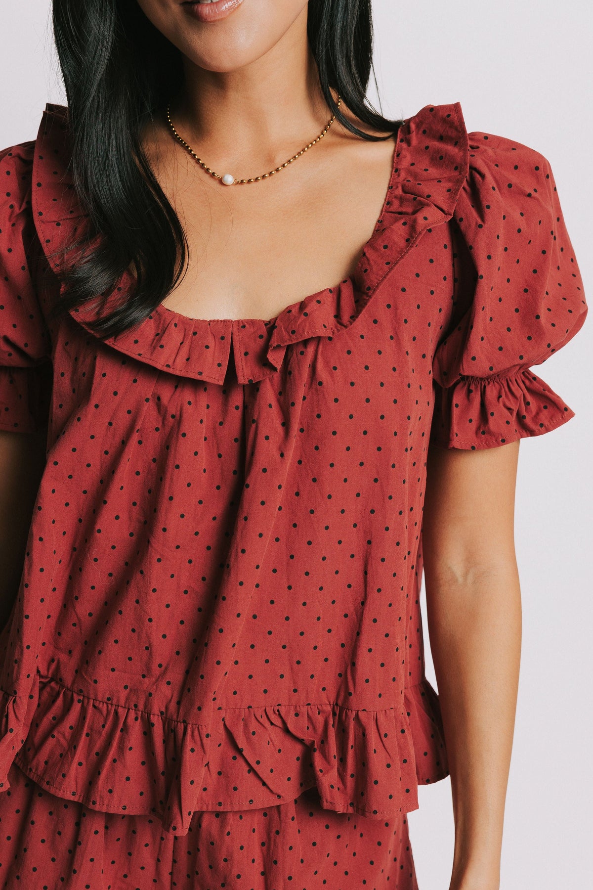 red top with black polka dots and puff sleeves front