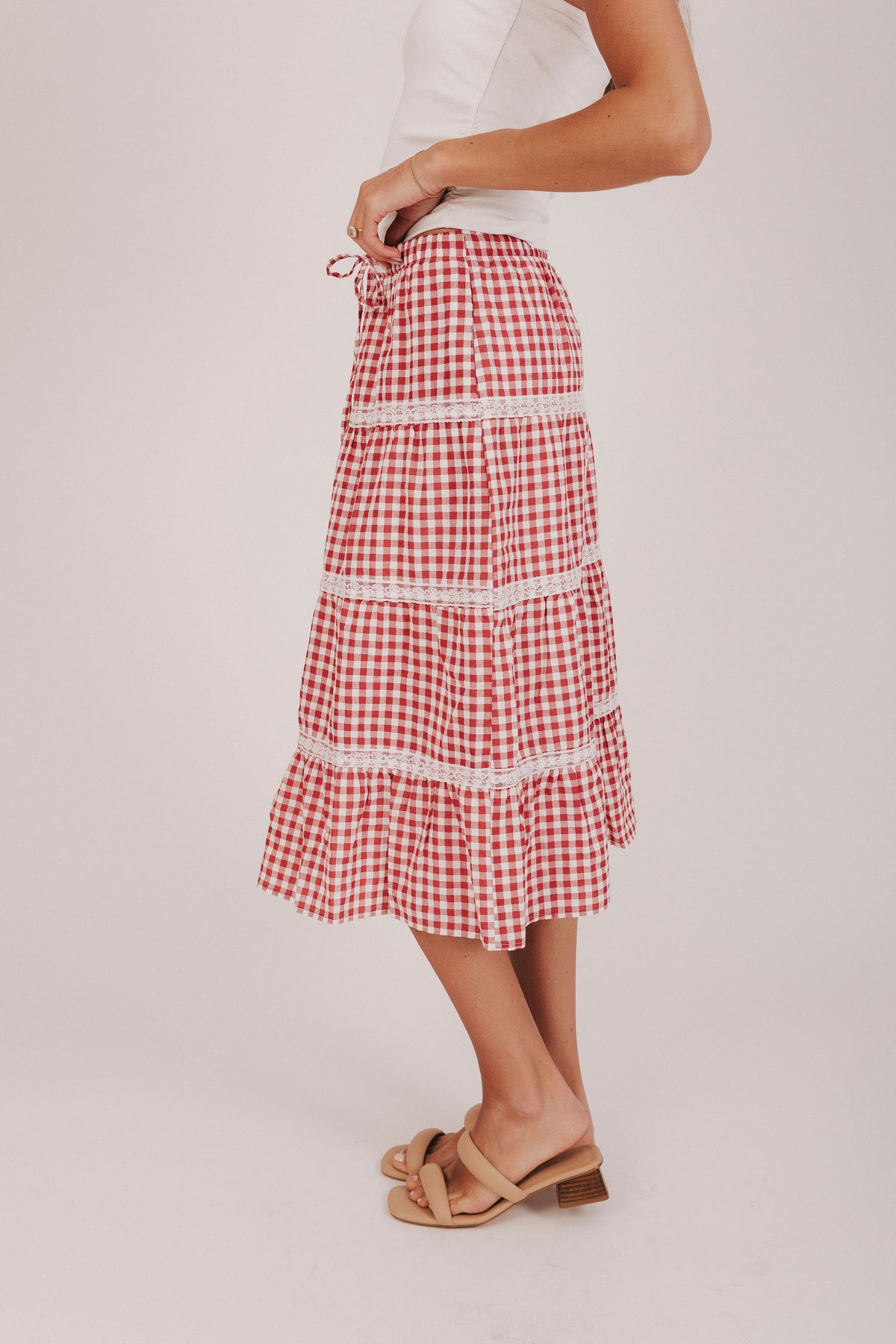 Red and white gingham midi skirt with lace trimmed tiers and a tied bow 