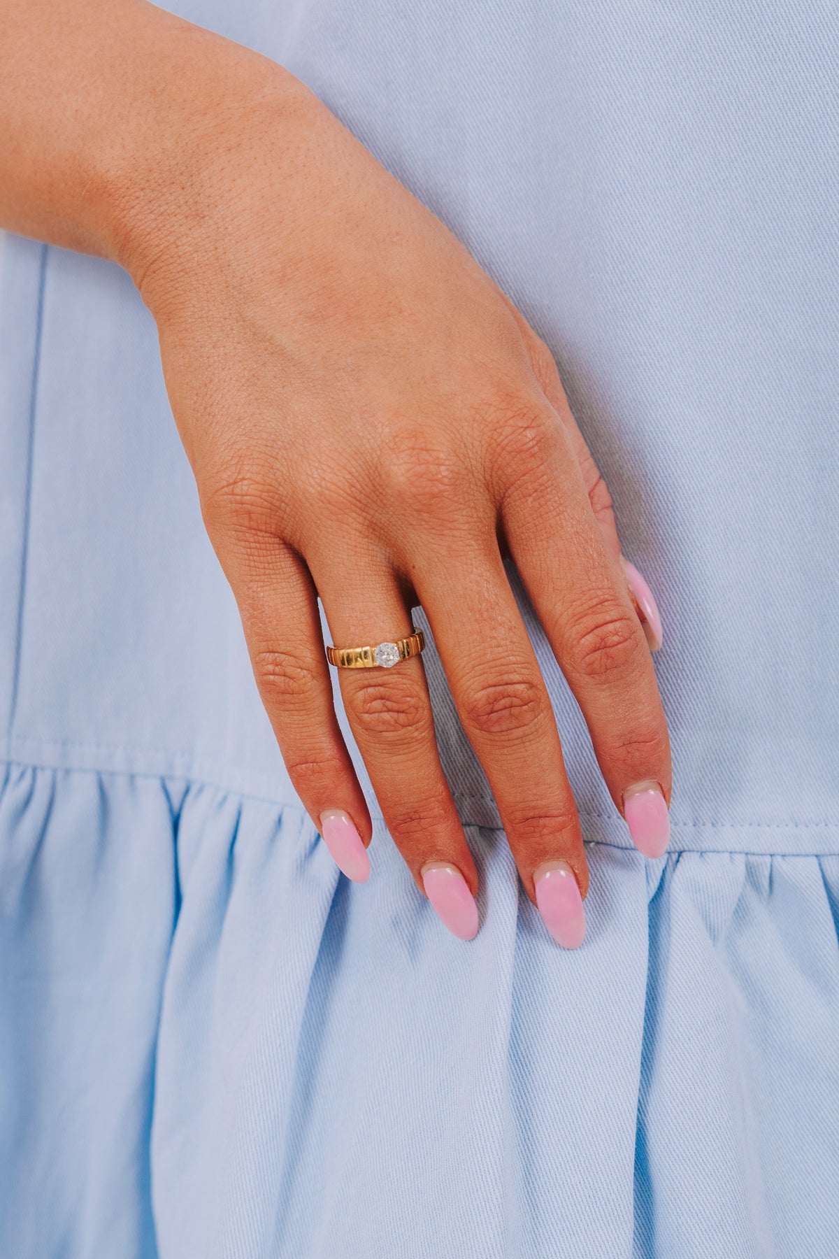 Stripe textured gold ring with diamond center