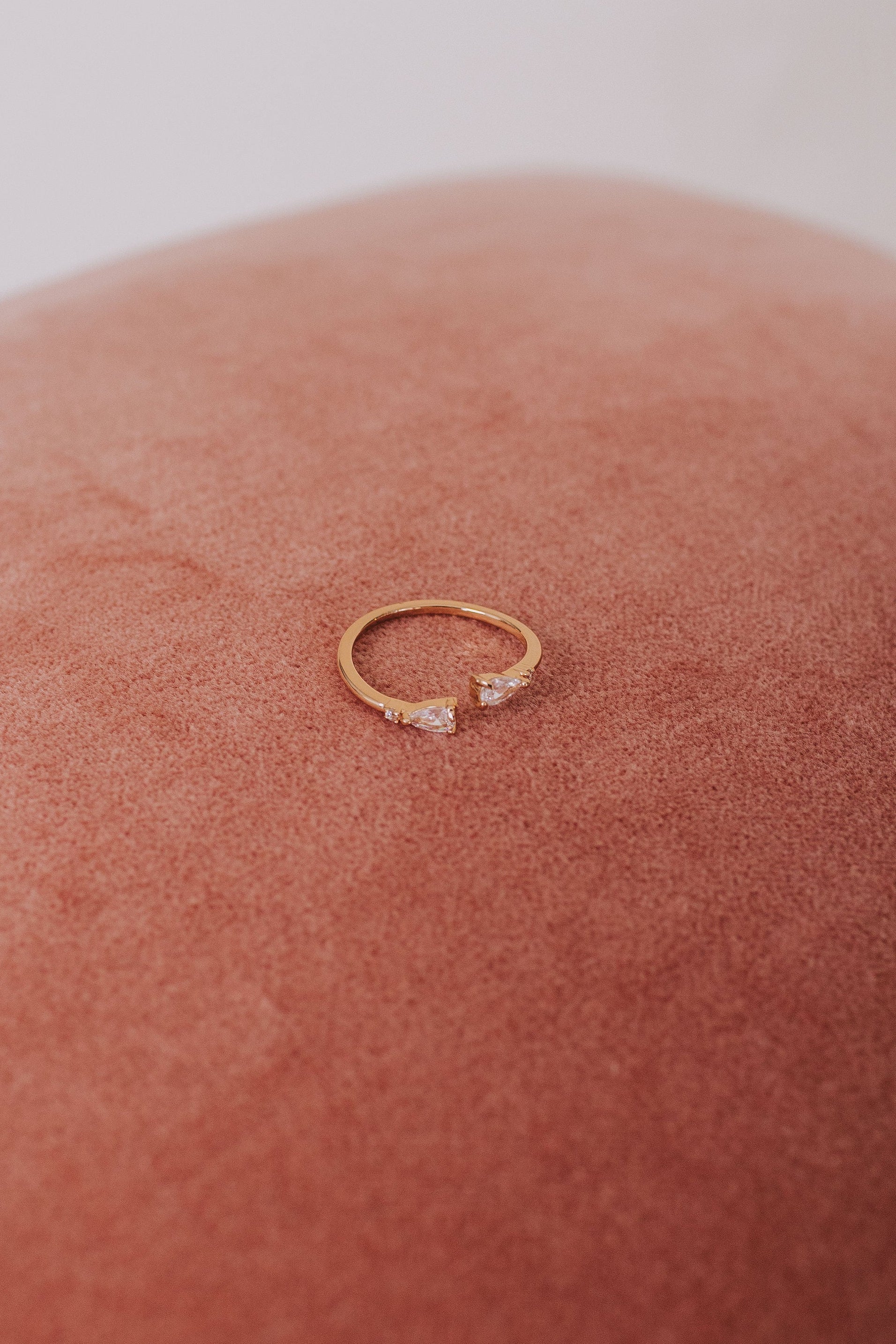 Gold ring with small diamonds on a pink cushion