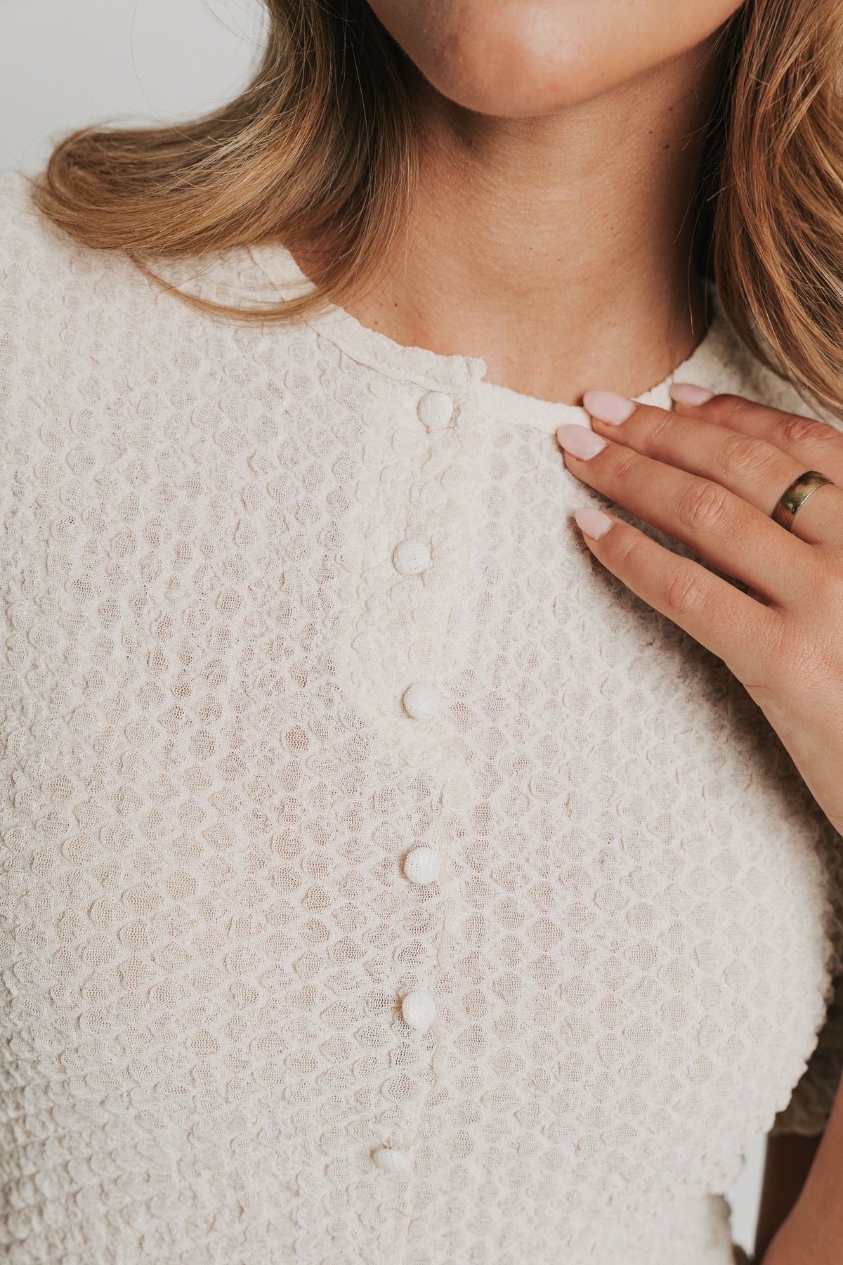 sand colored top with buttons and halfway center opening 