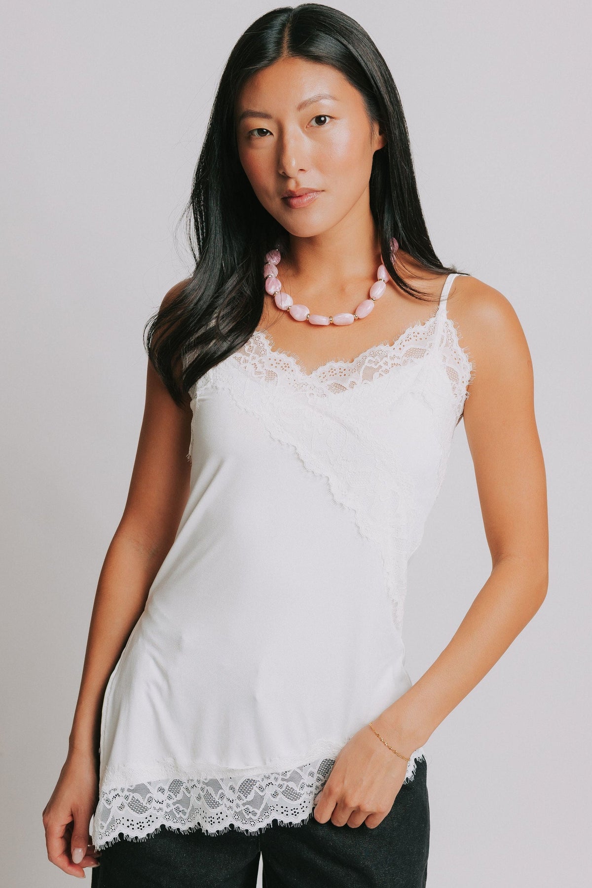 satin top with asymmetric hemline and lace trim
