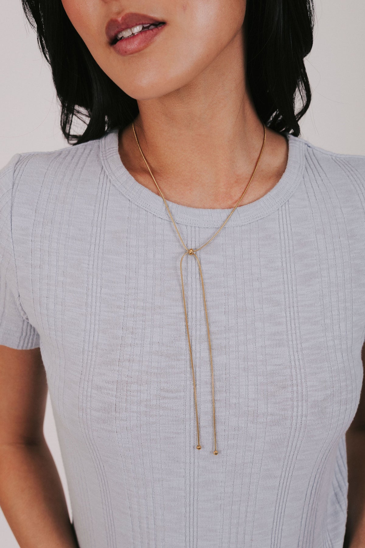 Gold plated snake chain necklace that's slider style with ball bead accents 