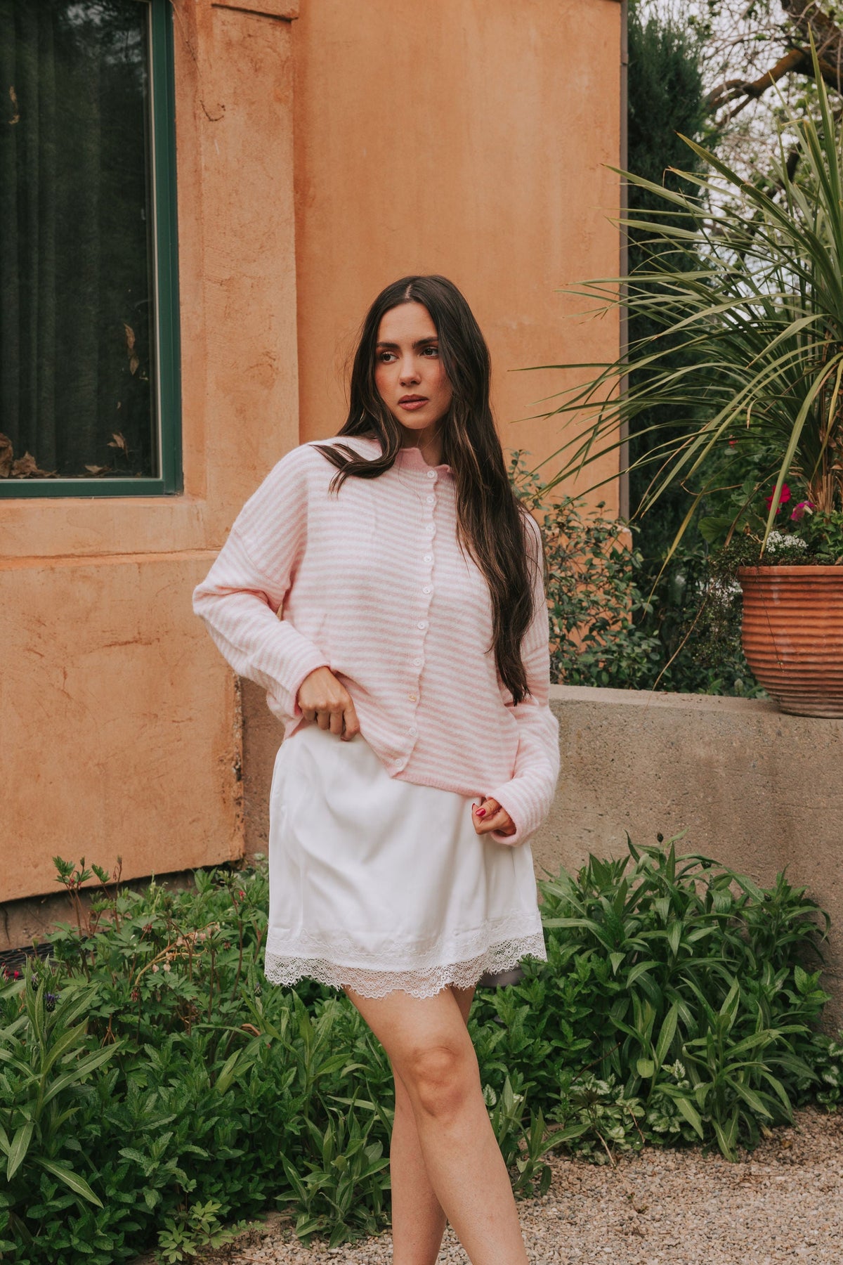 Off white and pink striped sweater with a button down front. Super soft material with rolled edges, long sleeves, and drop shoulders. 