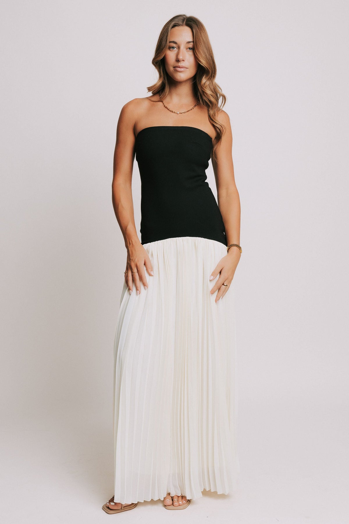 strapless maxi dress with black bodice and white pleated skirt full
