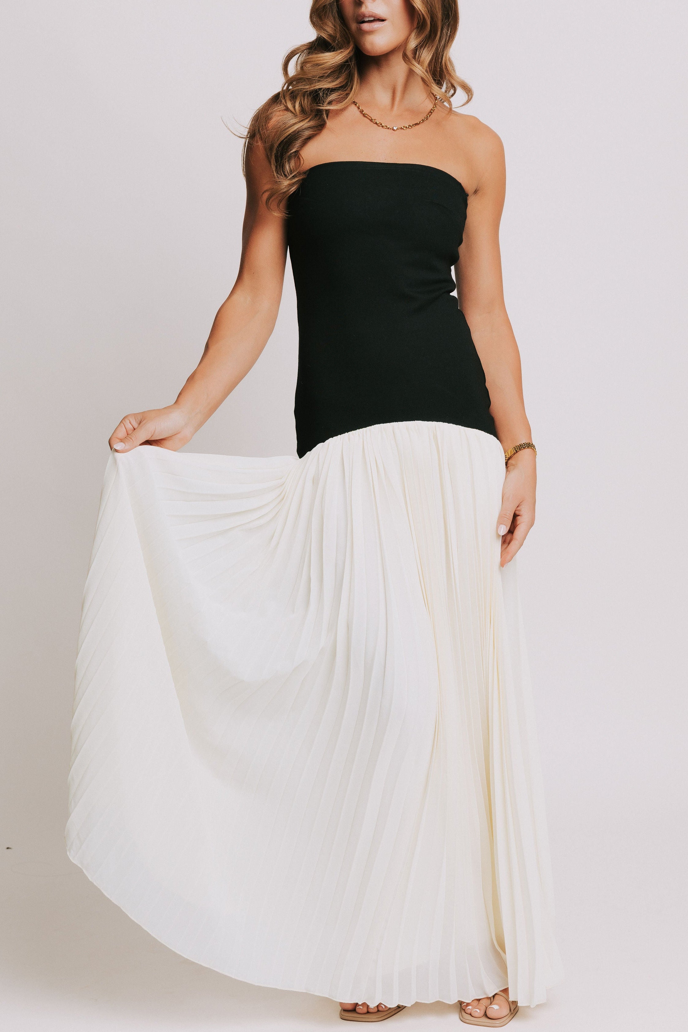 strapless maxi dress with black bodice and white pleated skirt 