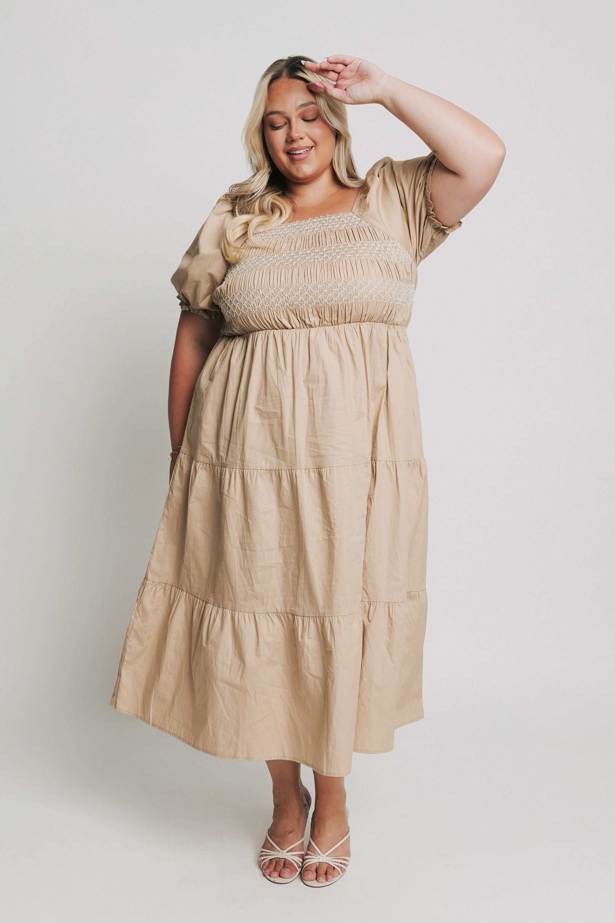 tan tiered midi dress with white embroidery on the bodice 