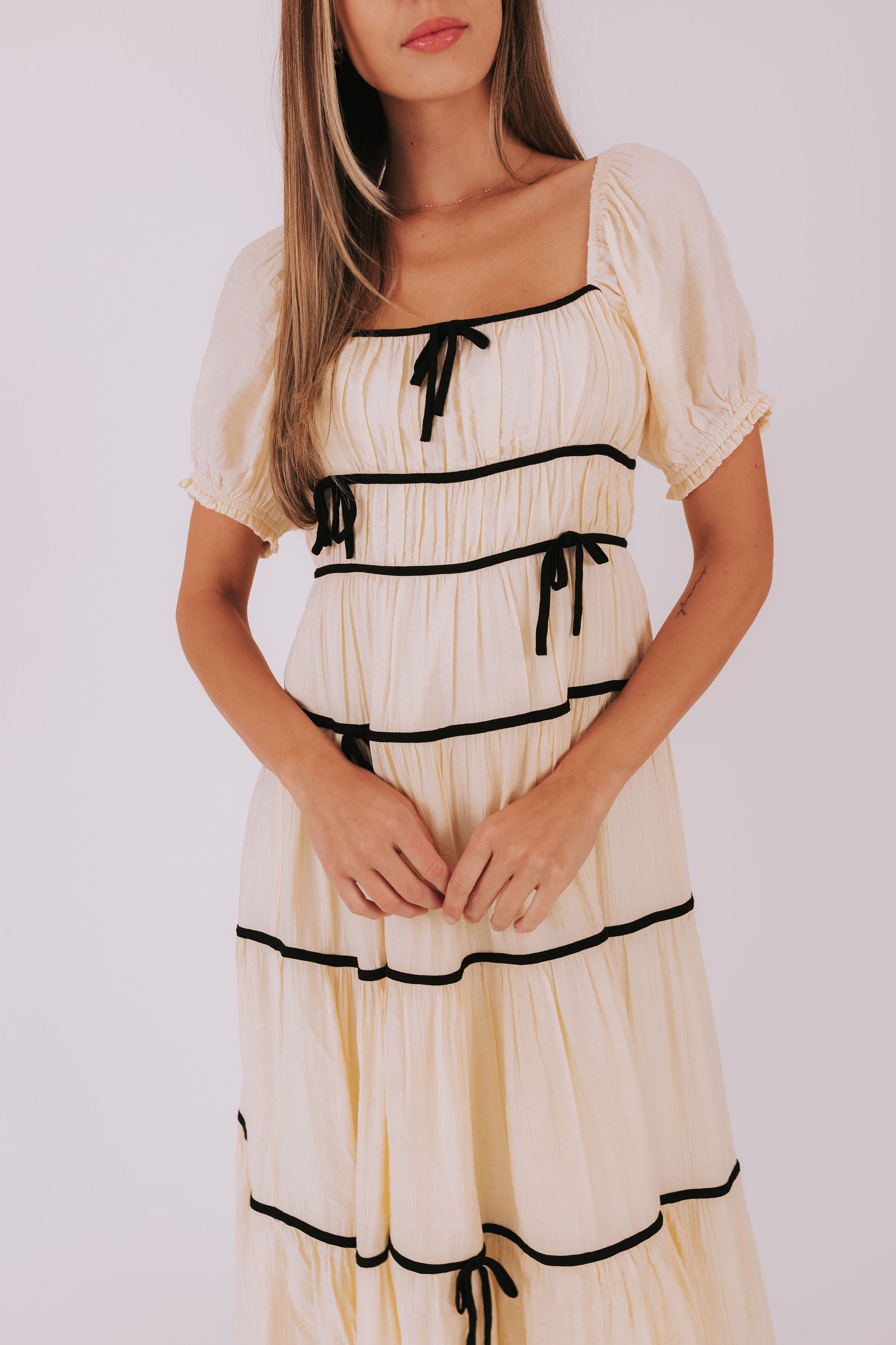 Maxi midi dress with piped details puff sleeves square neckline bow details 