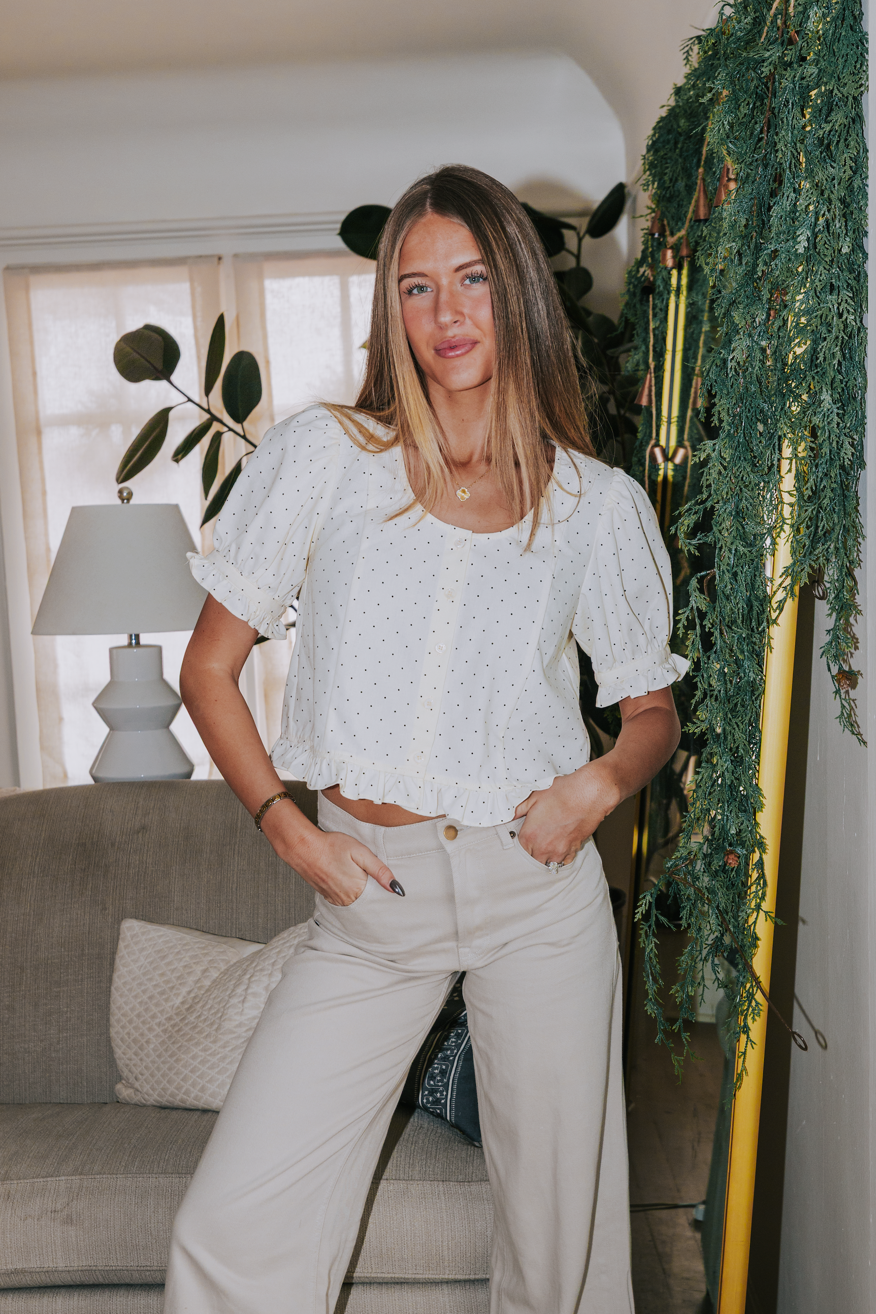 white blouse with black polka dots, short puff sleeves, ruffled hem.