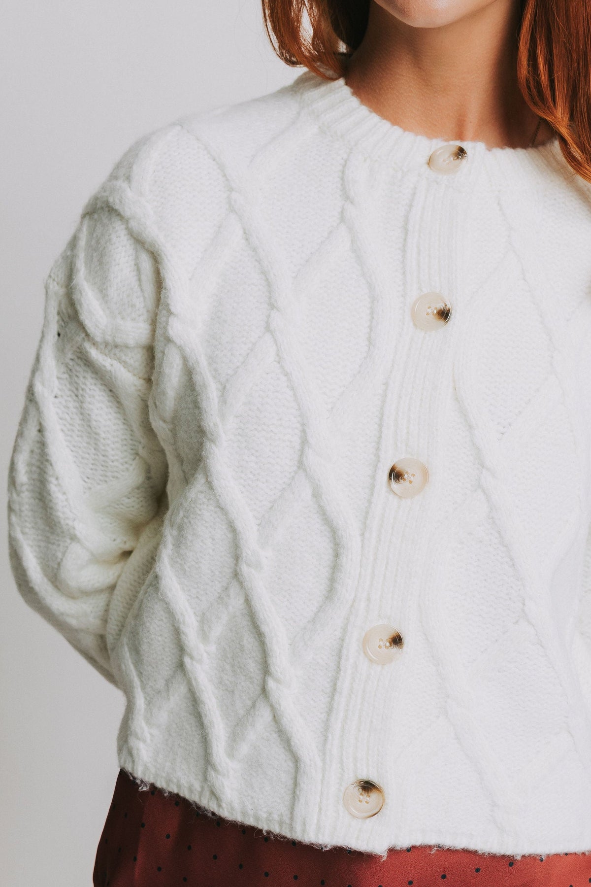 white cable knit cardigan close