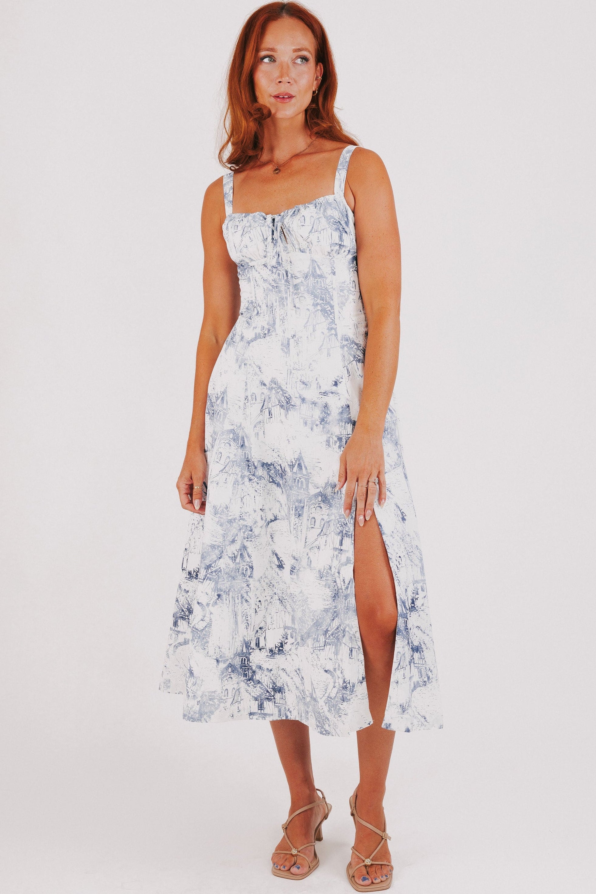 white dress with blue city print and structured bodice full
