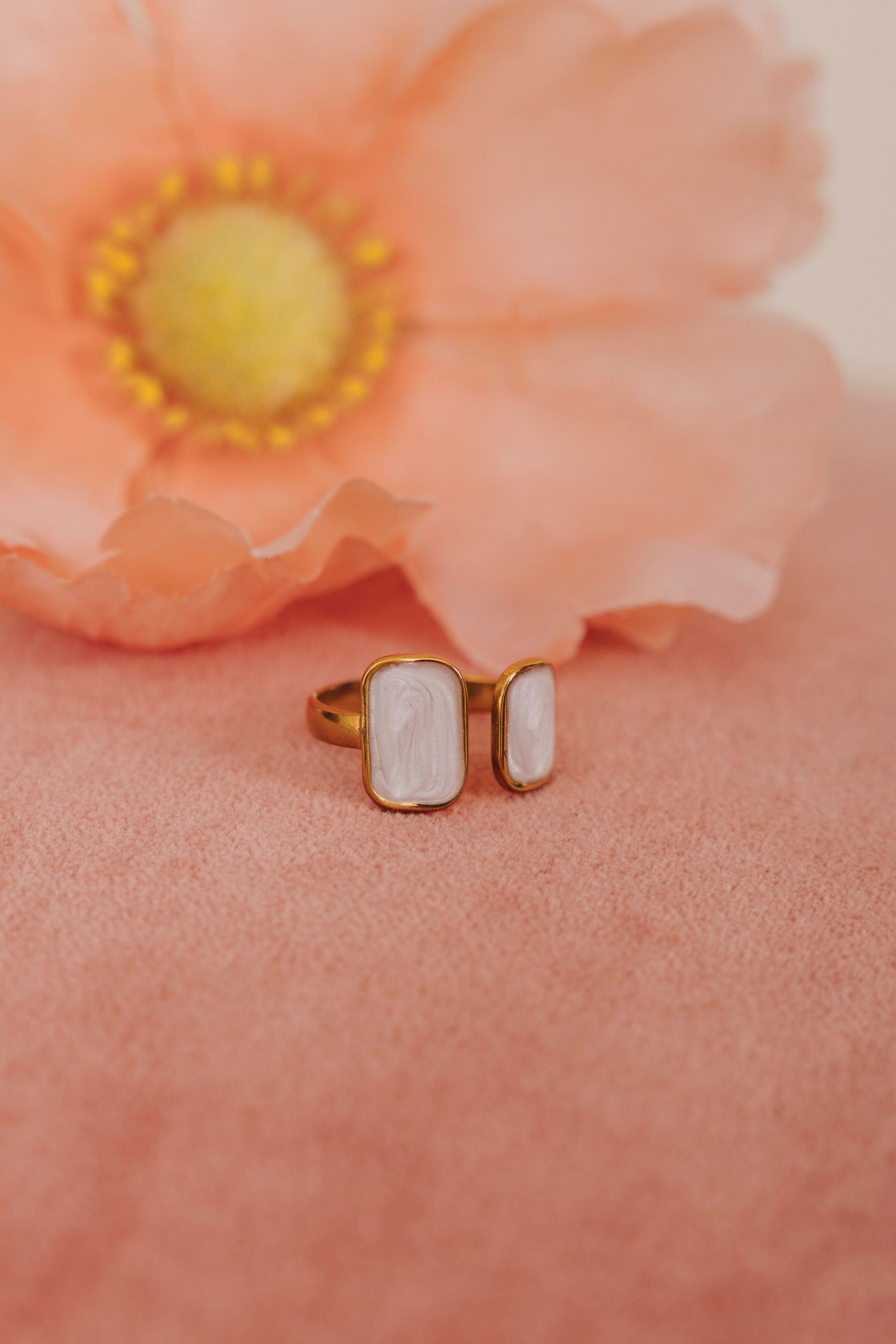 Gold open cuff ring with asymmetrical sized white rectangles 