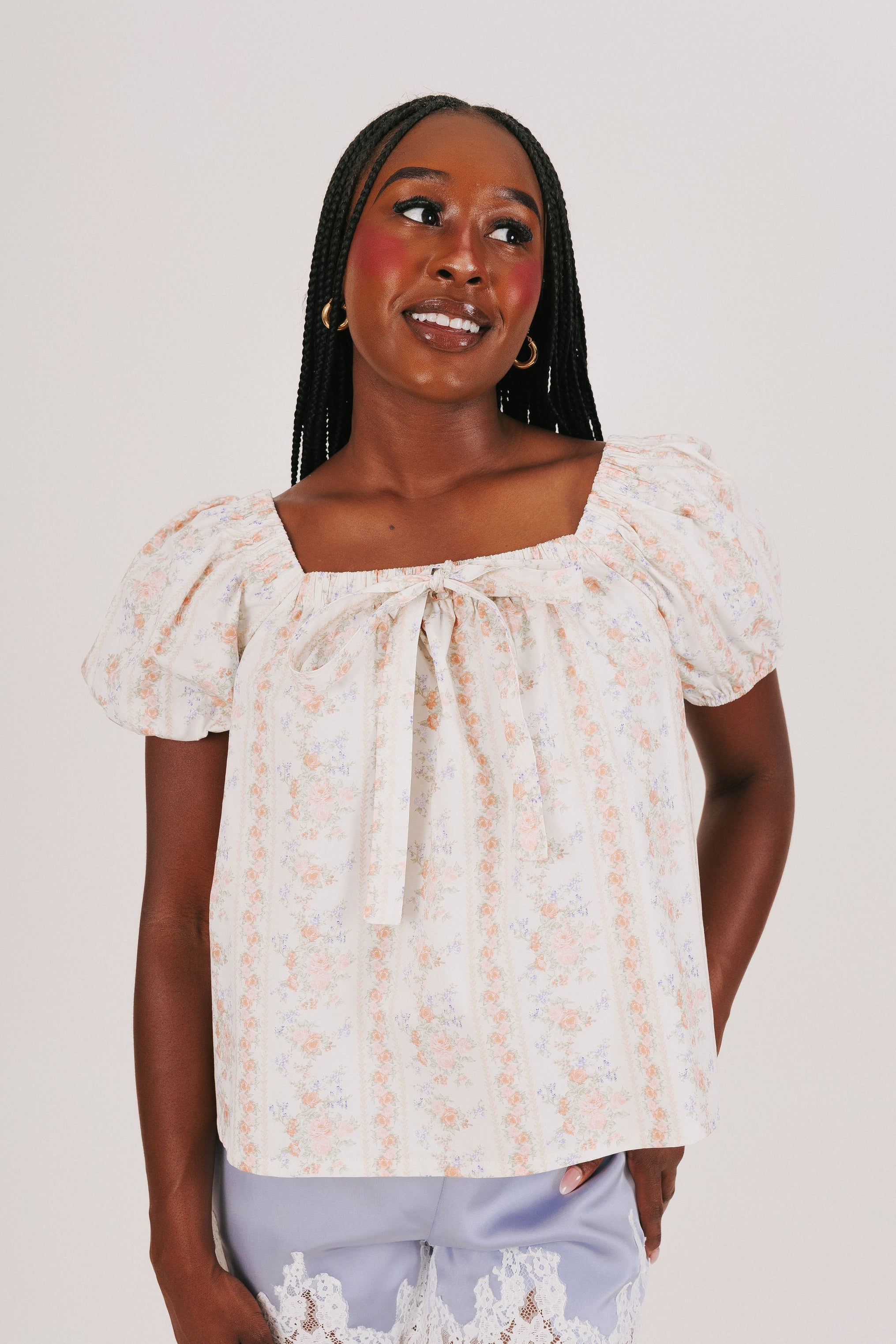 white puff sleeve top with floral pattern and bow