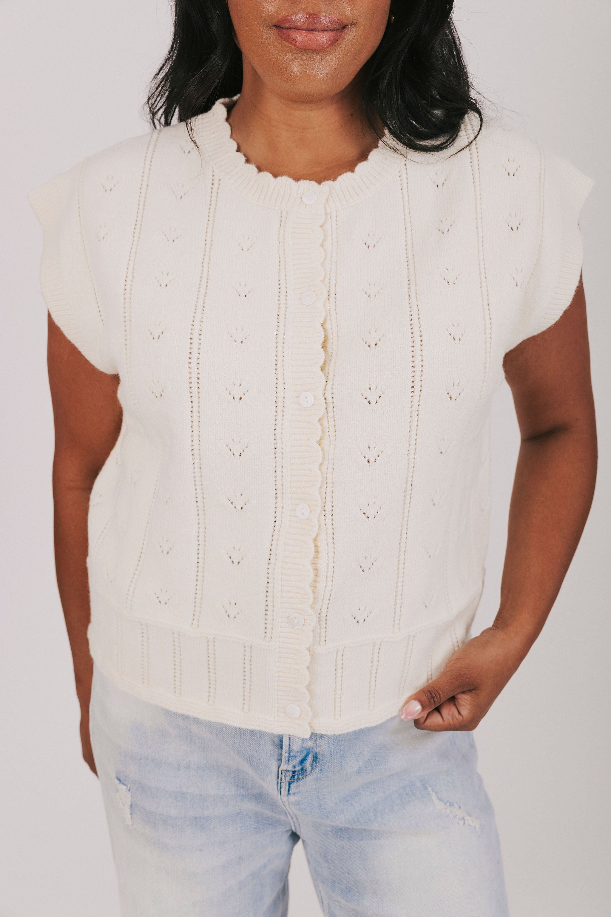Cream button down knit blouse with scalloped edges and pointelle details 