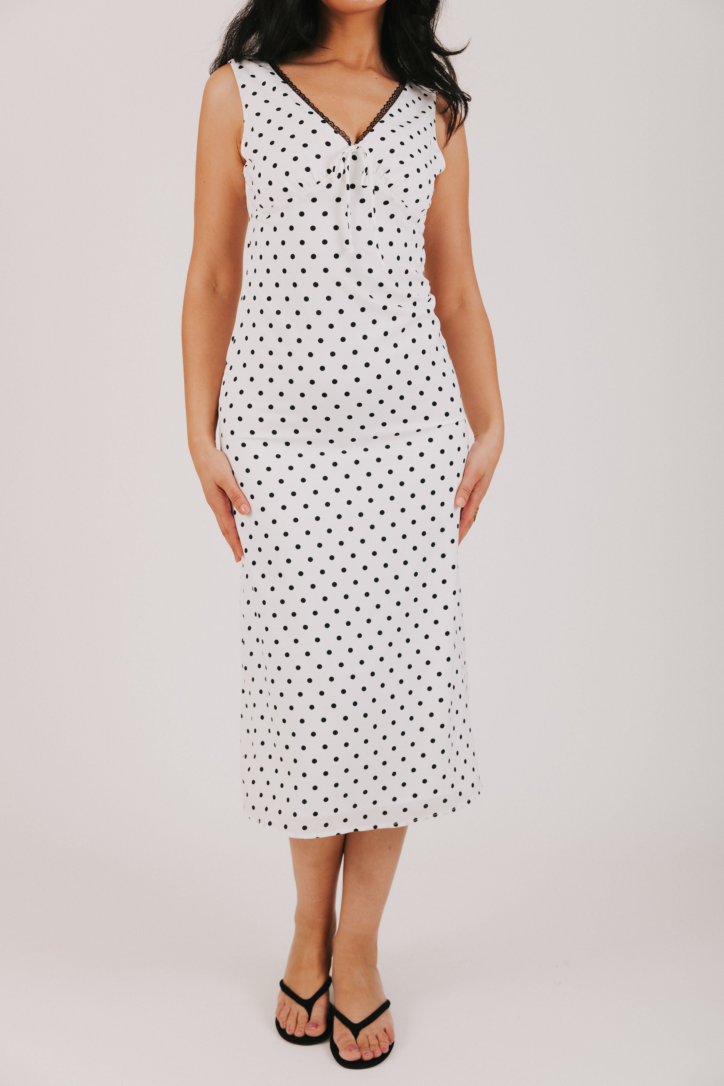 white v neck dress with black polka dots