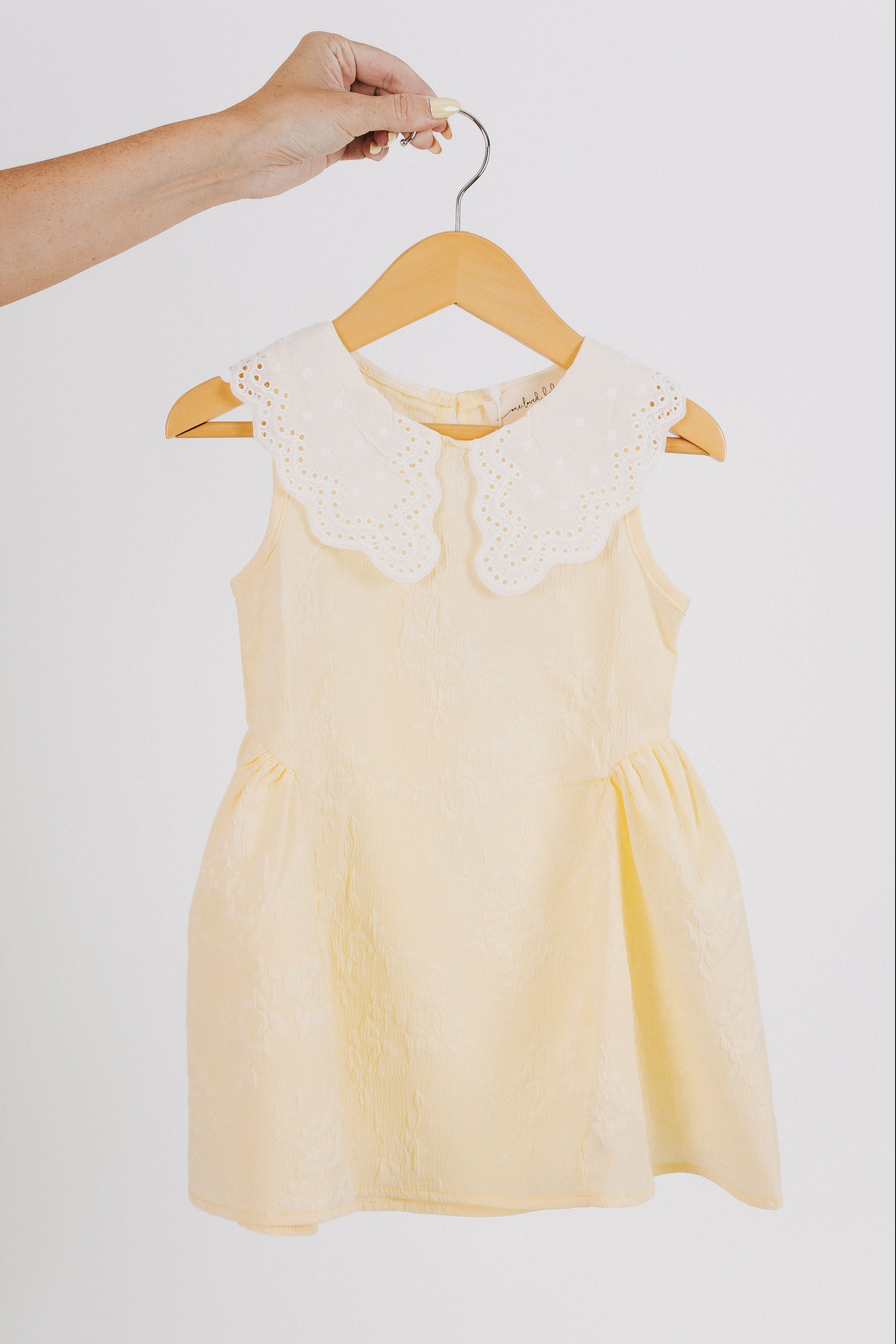 yellow baby dress with white eyelet collar