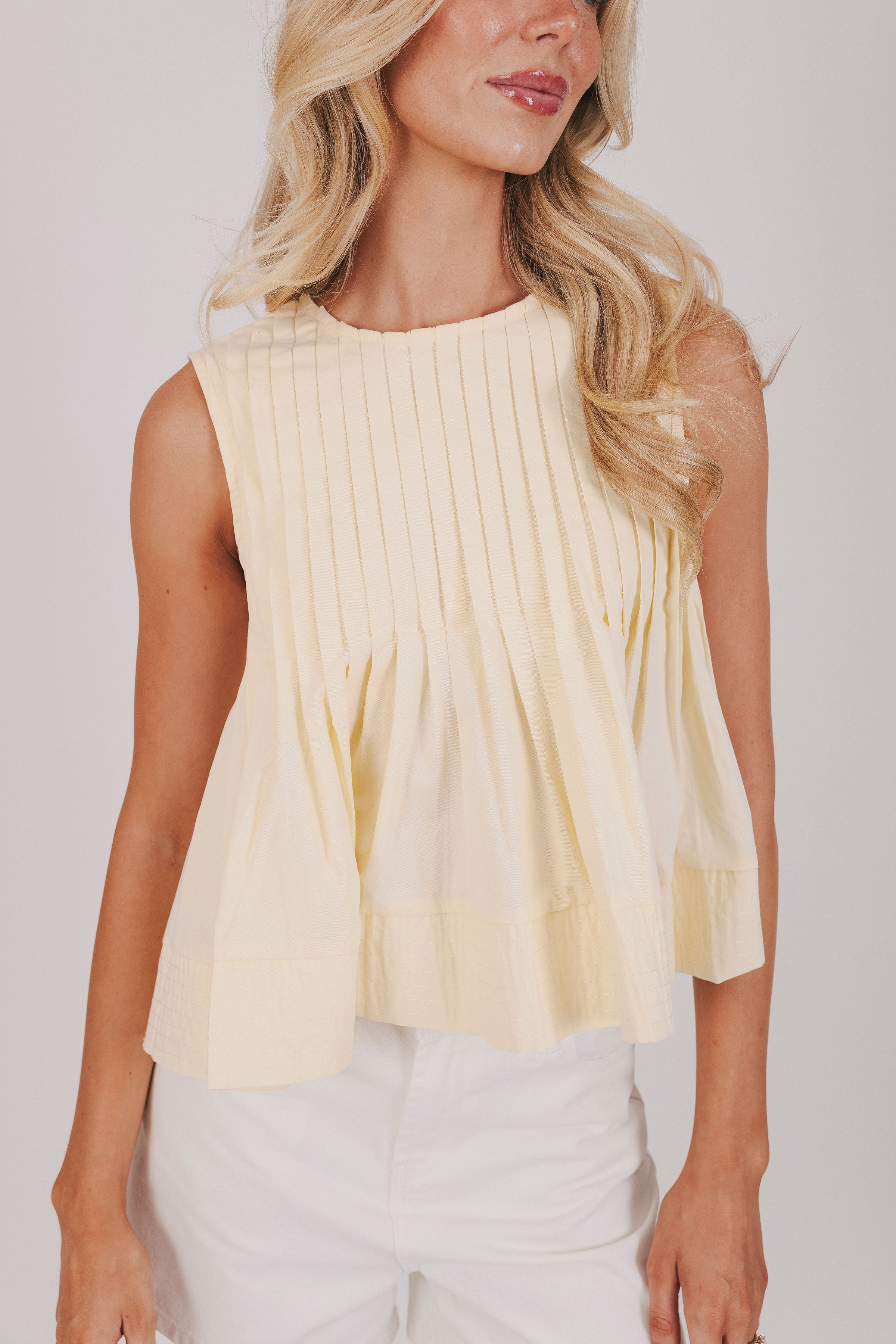 yellow sleeveless peplum top